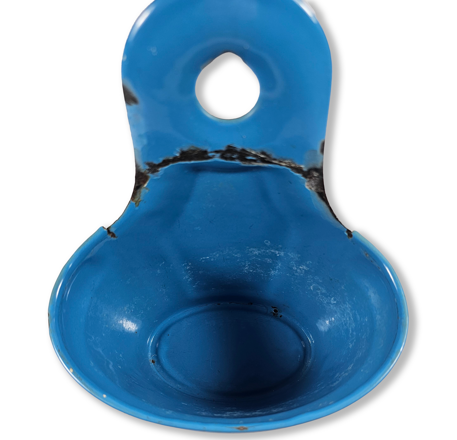 Close up of a Vintage Blue Enamel “SODA” Wall Mount Container inside