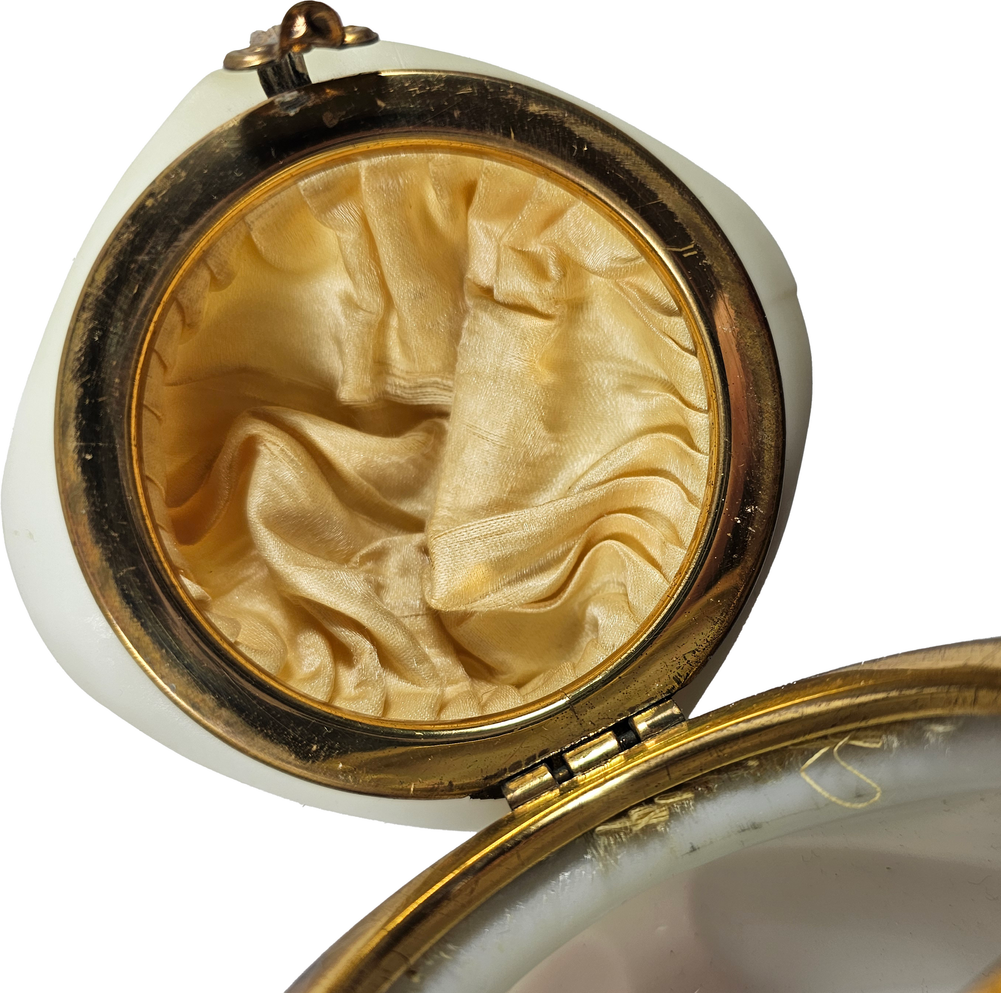 Close-up of a vintage trinket box with original upper silk lining.