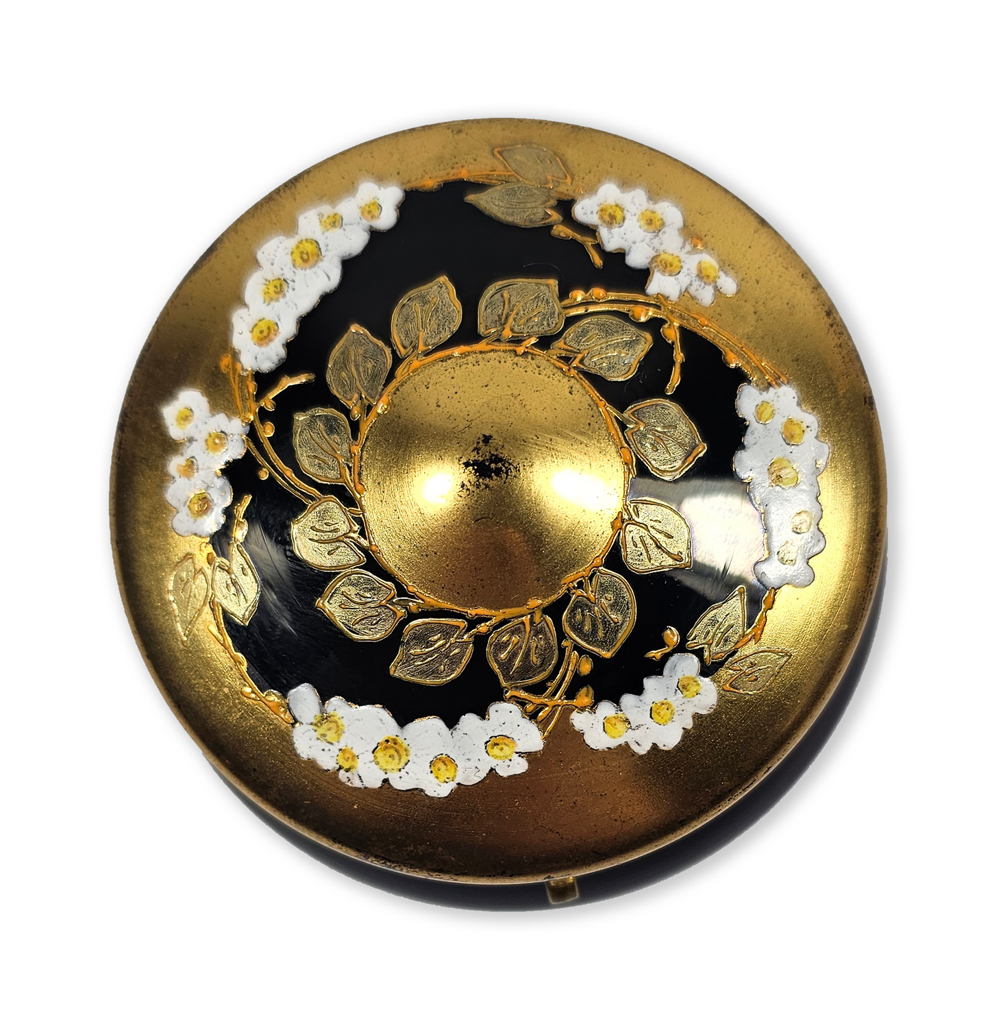 Decorative button with gold and black design on a white background