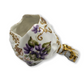 Decorative ceramic item with floral design and gold accents on a white background