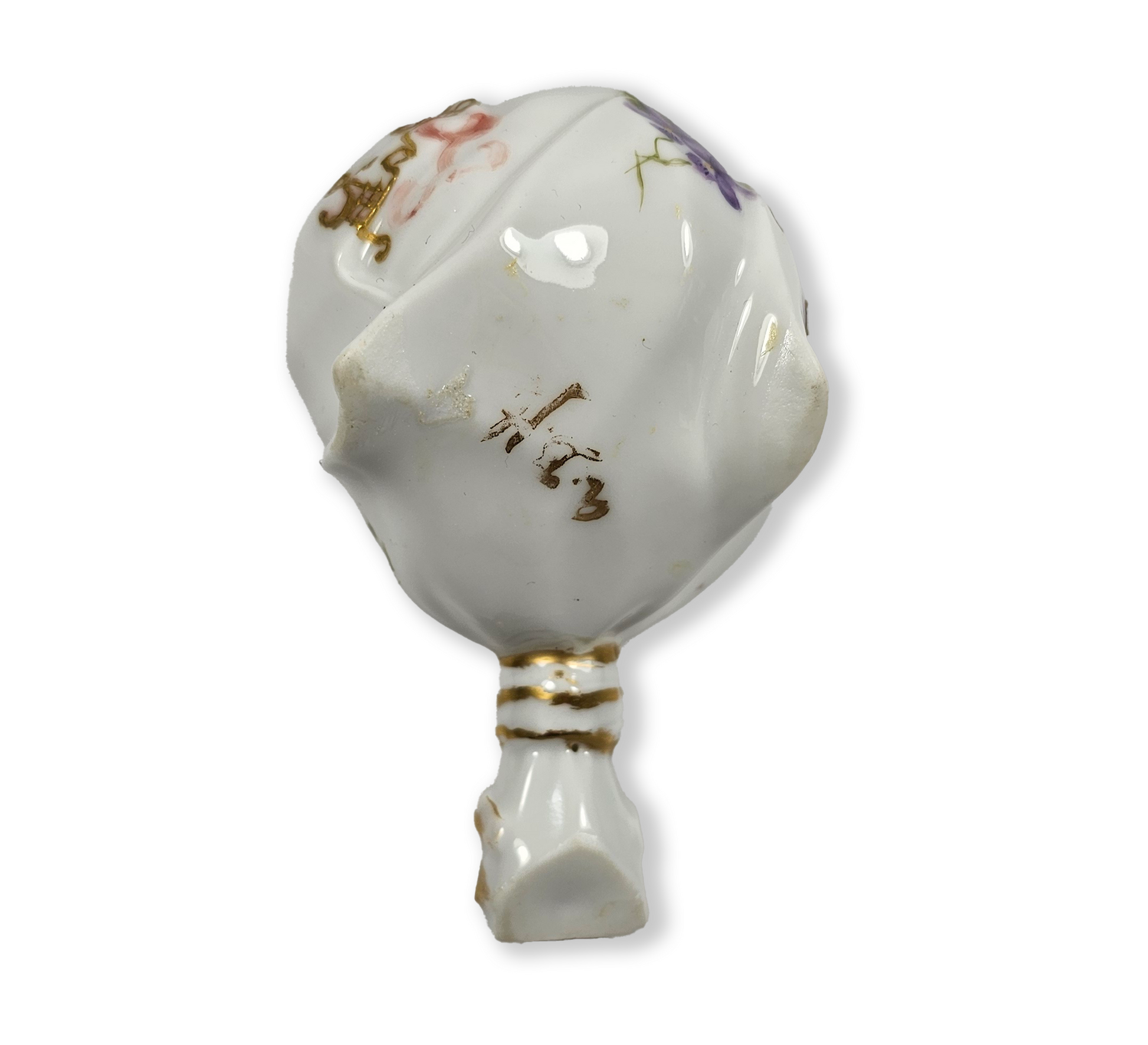Decorative ceramic flower holder with gold accents and floral patterns on a white background