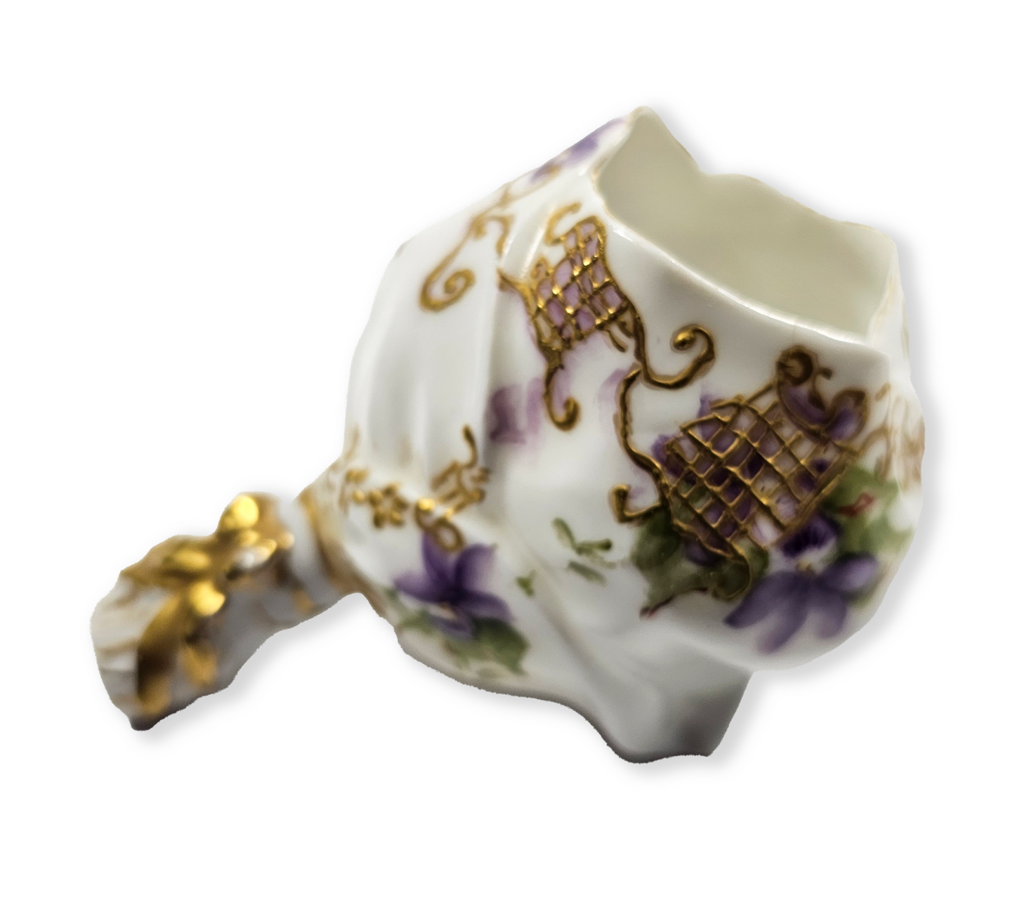 Decorative ceramic flower holder with gold accents and floral patterns on a white background