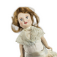 antique doll with brown hair and a white dress on a white background