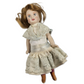 Vintage doll with lace dress on a white background