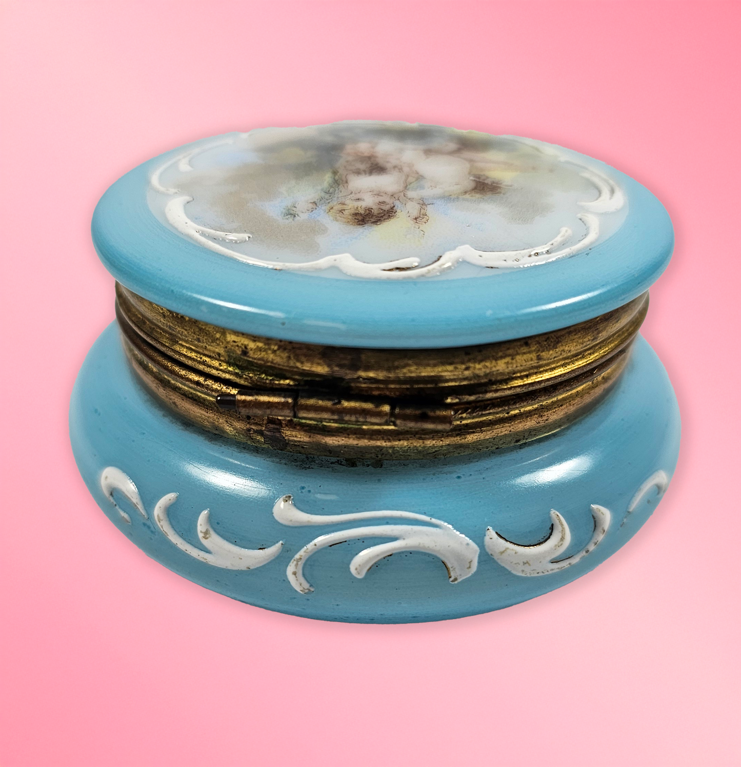 Decorative blue box with gold accents on a pink background
