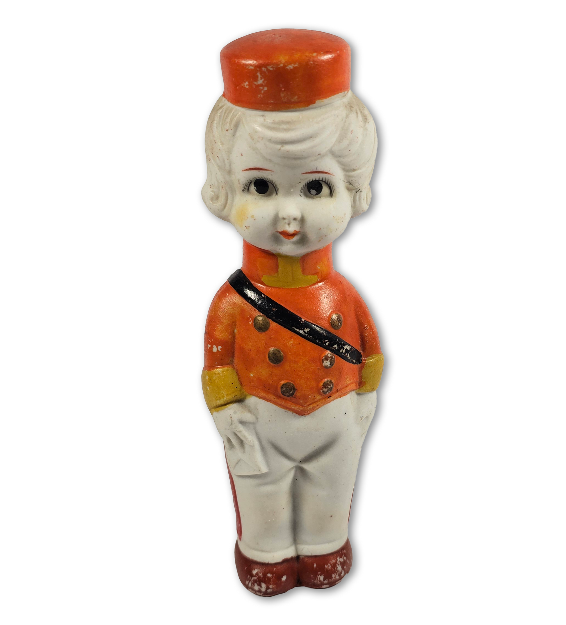 Vintage toy figure in military uniform with red hat on a white background