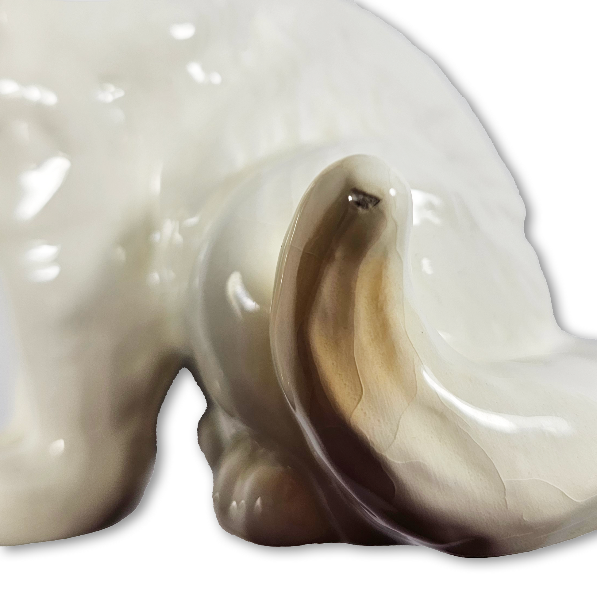 Close-up of a ceramic cat figurine with a white background