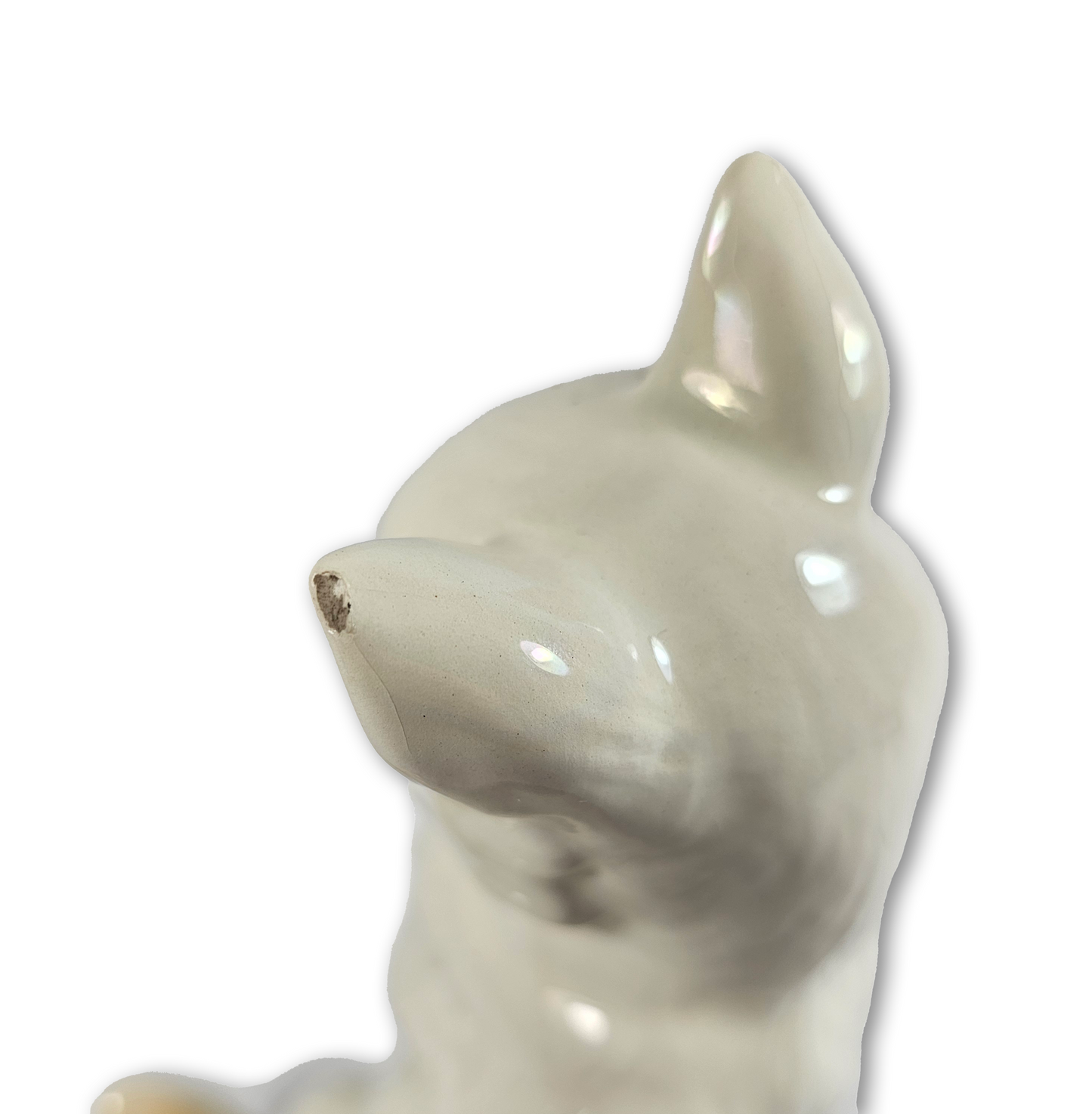White ceramic cat figurine on a white background