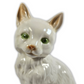 Ceramic cat figurine with green eyes on a white background