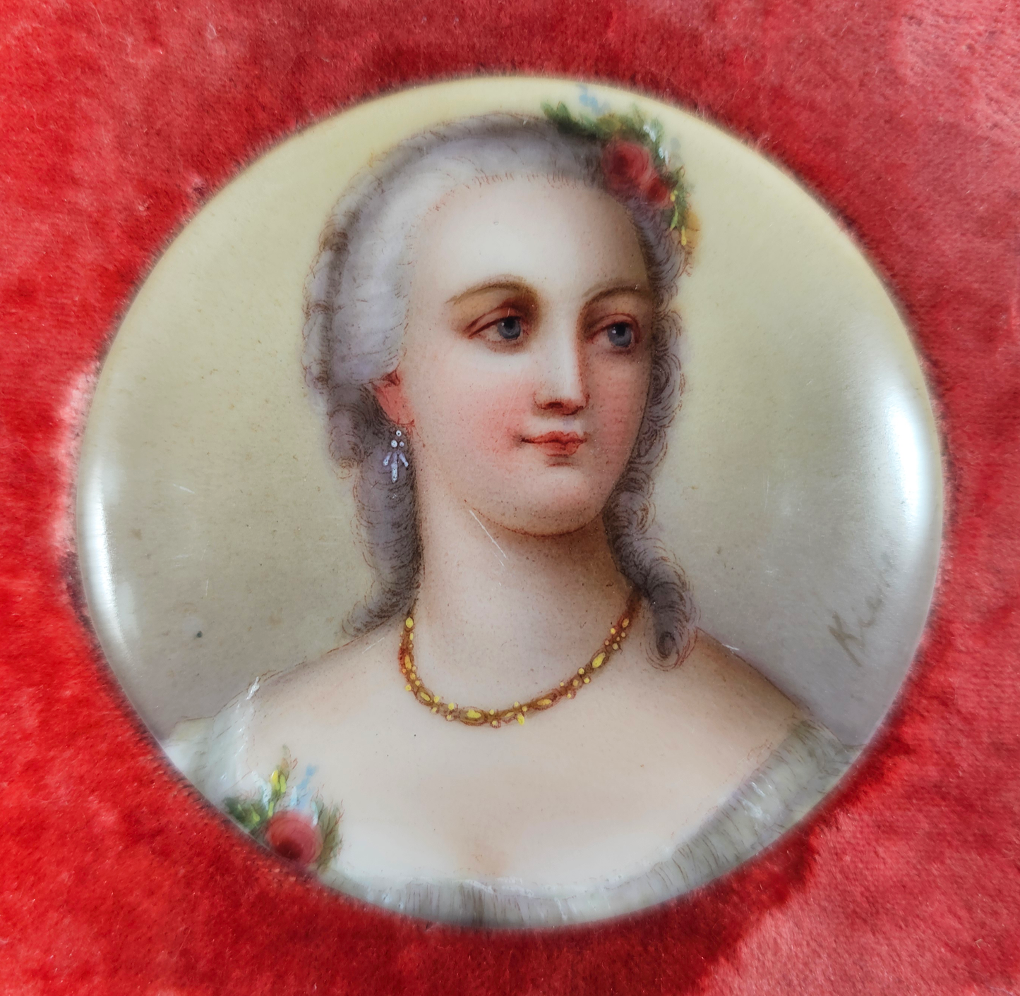 Miniature portrait of a woman with floral hairpiece on a red background