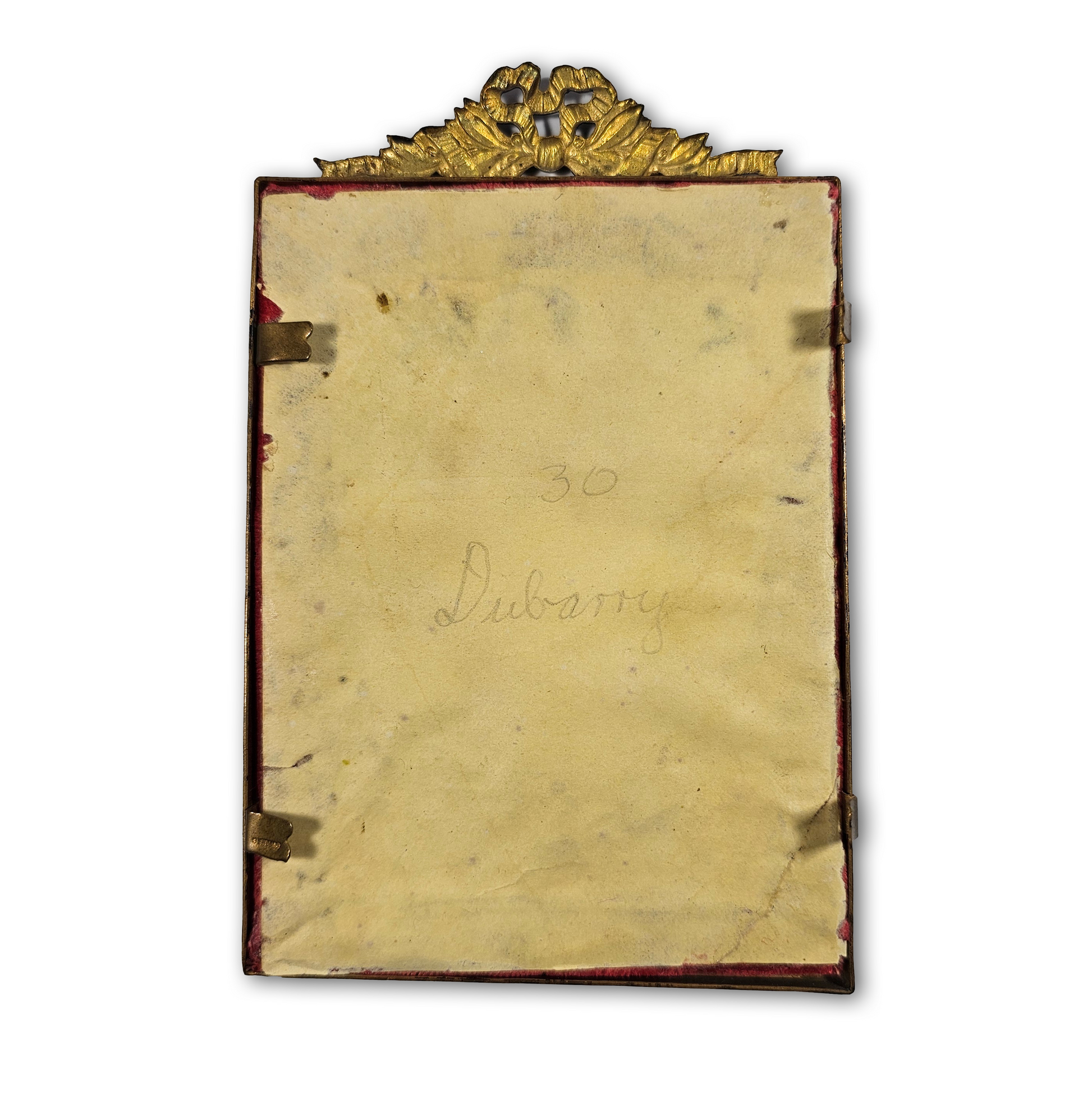 Vintage gold-framed mirror with decorative top on a white background