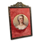 Portrait of a woman in a decorative frame with a red background