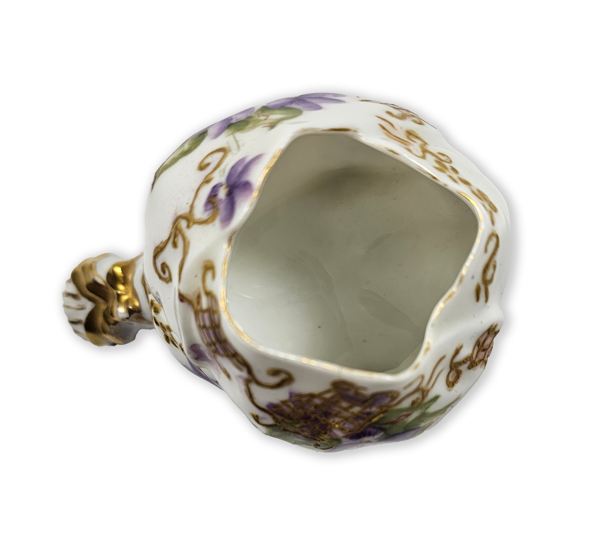Decorative ceramic flower holder with gold accents and floral patterns on a white background