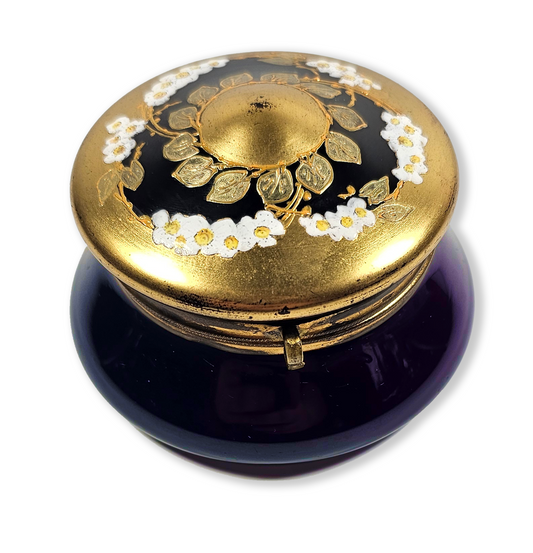 Decorative purple box with gold lid featuring floral designs on a white background