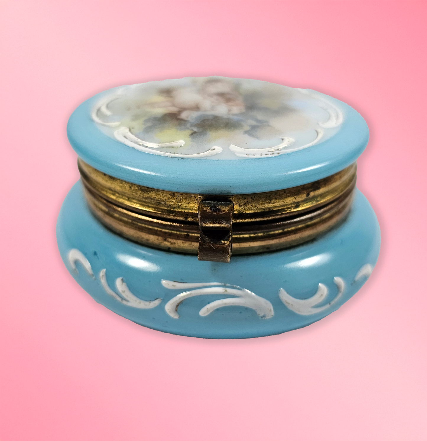 Blue decorative box with floral design on a pink background