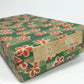 Vintage box with floral pattern and 'Made in Occupied Japan' label on a white background