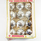 Box of clear Christmas ornaments labeled 'The Unbreakable Kind' on a white background