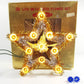 Decorative star-shaped lights in front of a gold box labeled '20 Lite Metalized Flower Set'.
