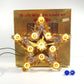 Decorative star-shaped light set in front of a vintage-style box labeled '20 Lite Metalized Flower Set'.