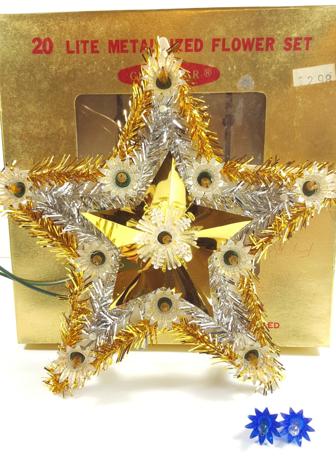 Decorative star with metallic flowers on a gold box labeled '20 Lite Metalized Flower Set'.